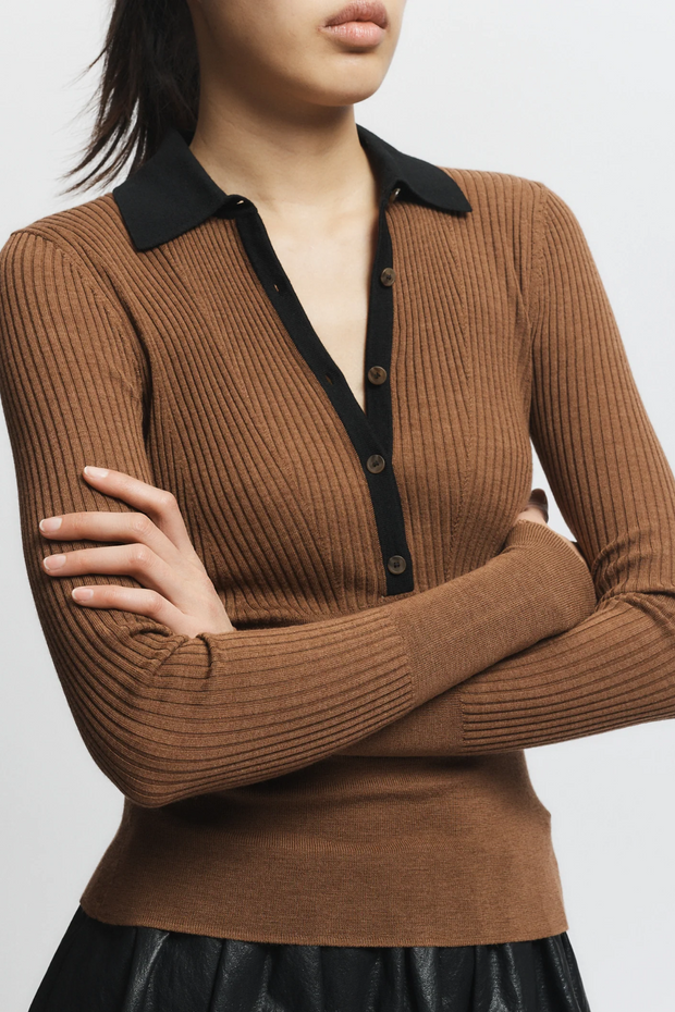 Brown ribbed sweater with black collar and buttons on a white background