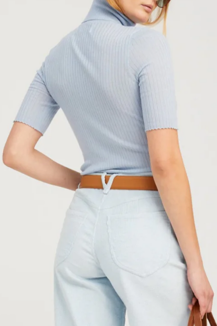 Light blue ribbed top and pants with a brown belt on a white background