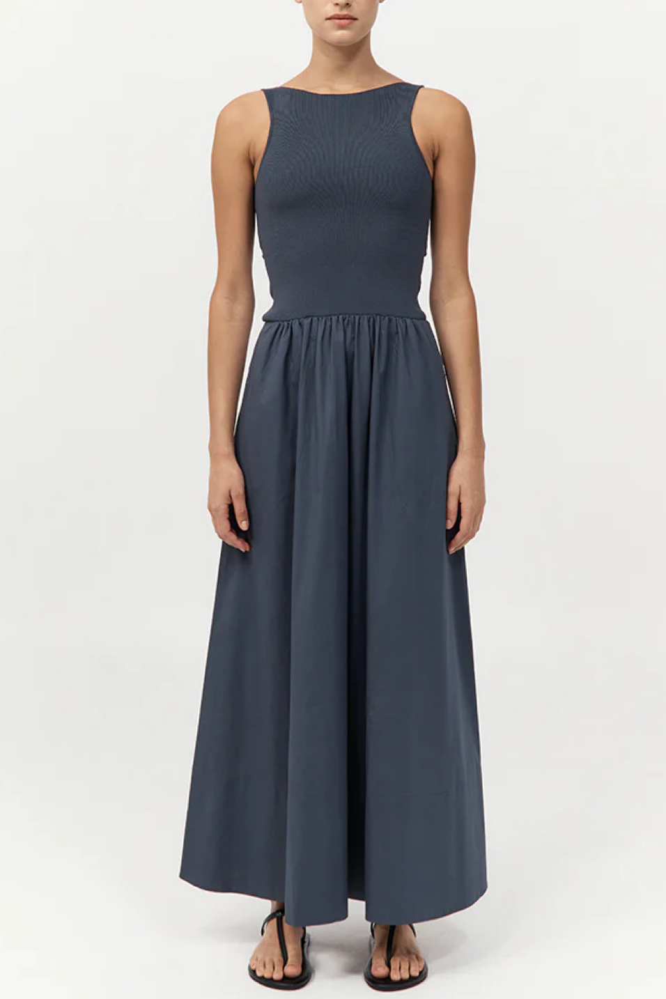 Woman wearing a sleeveless dress on a white background