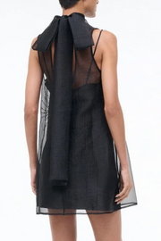 Black dress with bead embellishments on a white background