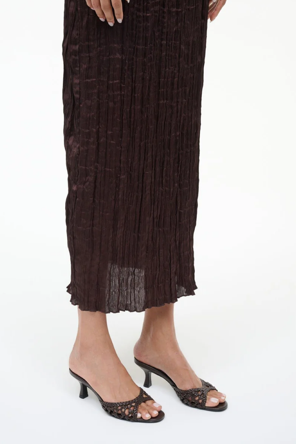 Brown textured skirt worn by a person on a white background