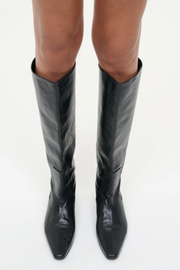 Black knee-high boots on a white background