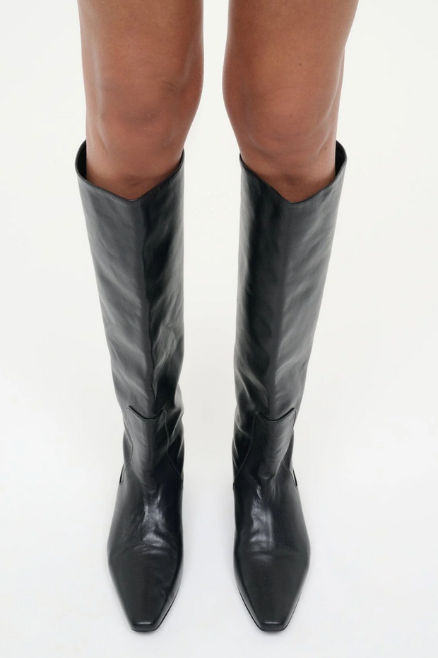 Black knee-high boots on a white background