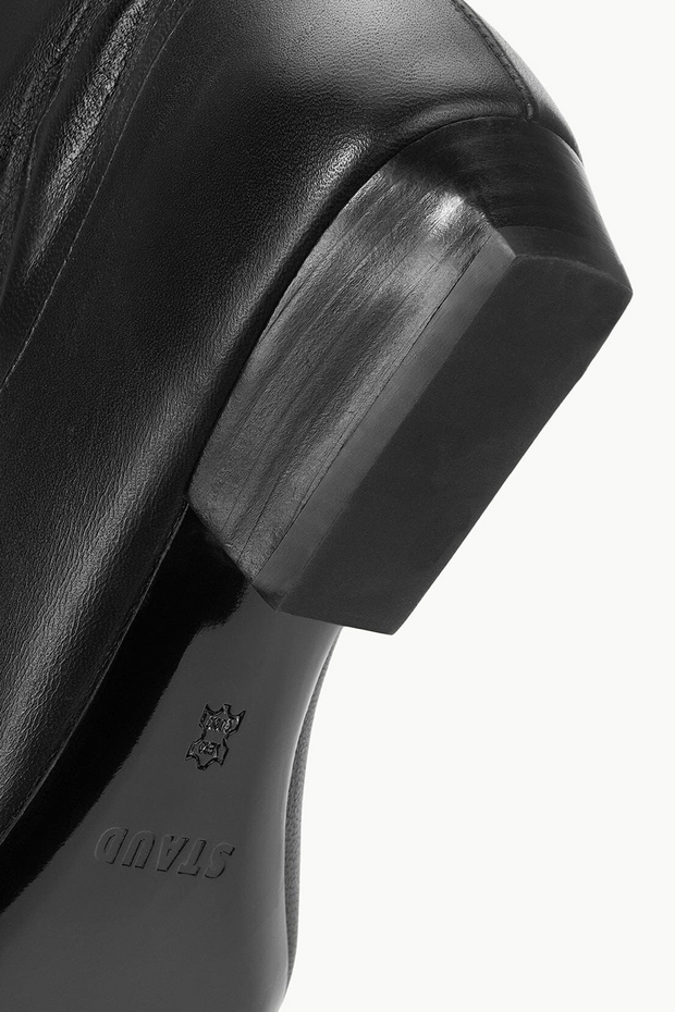 Close-up of a black shoe sole with on a white background