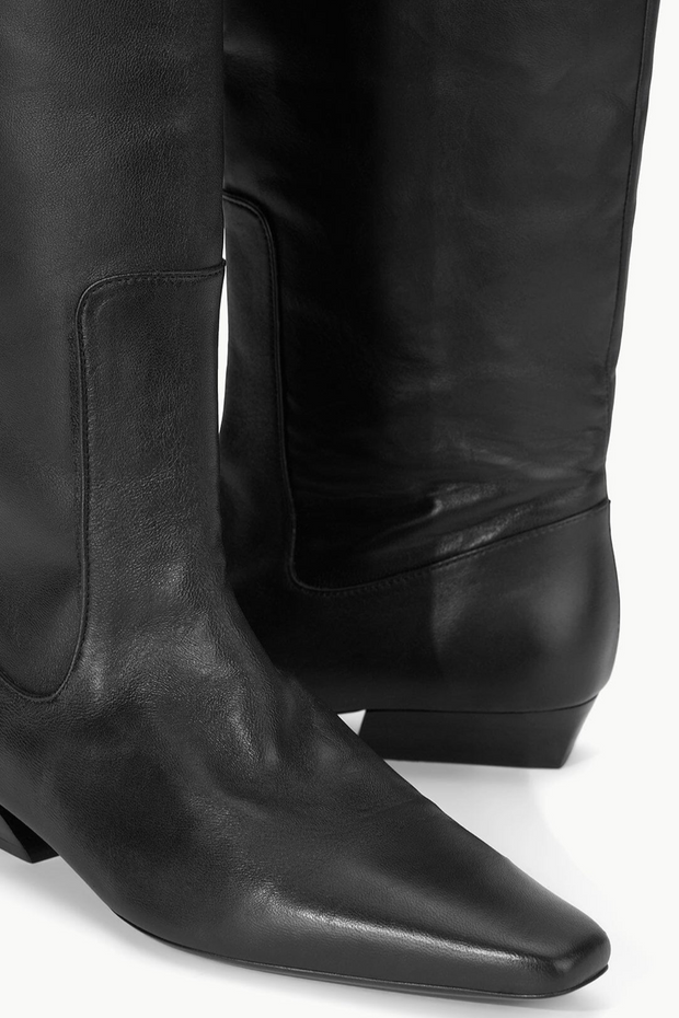Black leather knee-high boots on a white background
