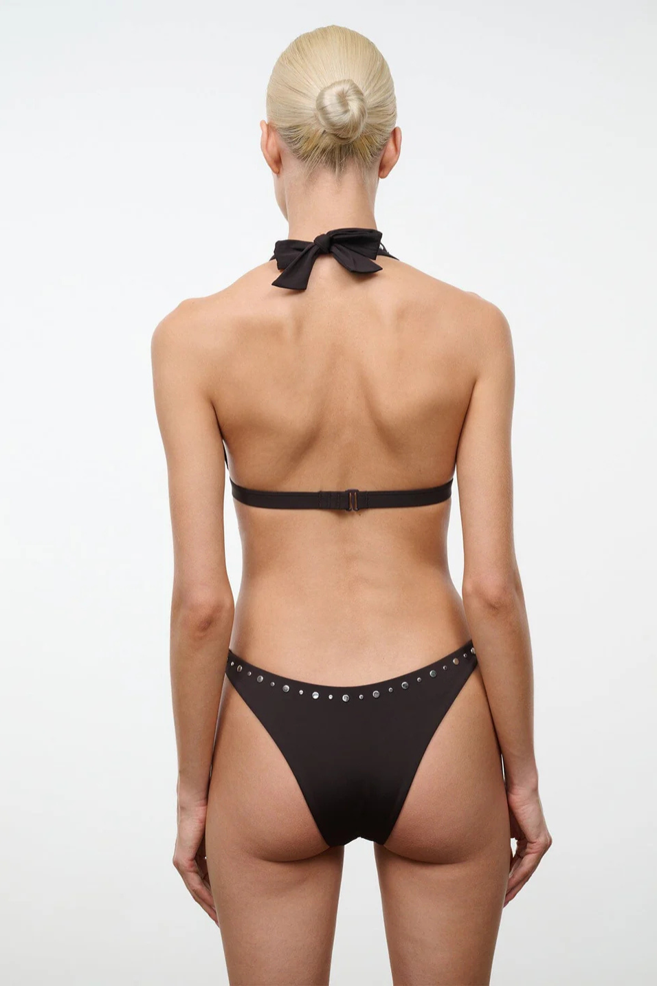 Person wearing a brown bikini on a white background