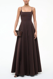 Woman wearing a brown evening gown on a white background