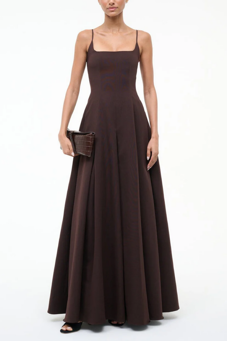 Woman wearing a brown evening gown on a white background