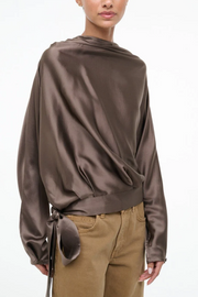 Silk truffle colored top worn by a model on a white background