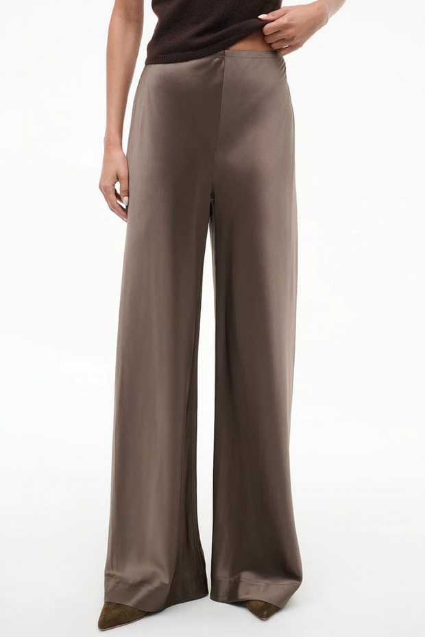 Silk truffle colored wide-leg pants worn by a person on a white background