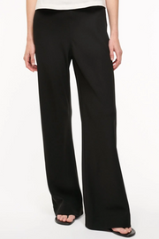 Black wide-leg pants worn by a person on a white background