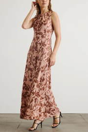 Woman wearing a floral dress with a plain background