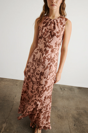 Woman wearing a floral dress against a plain background