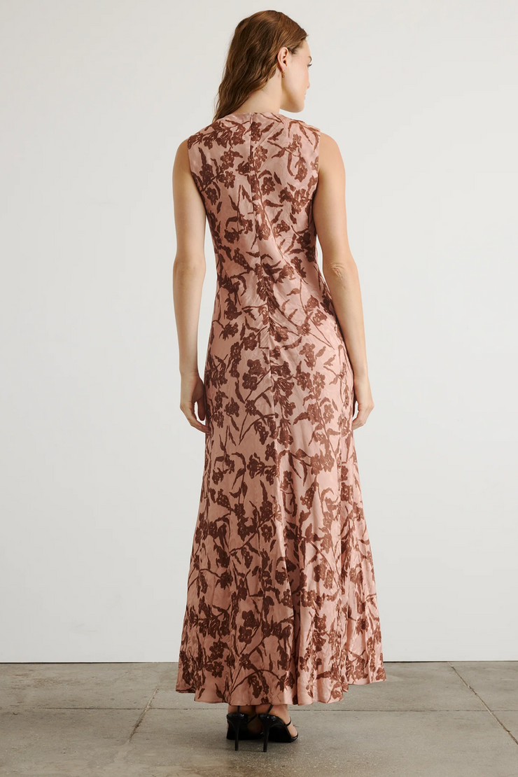 Woman wearing a floral dress with a plain background