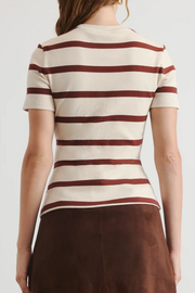 Person wearing a striped shirt with a plain background
