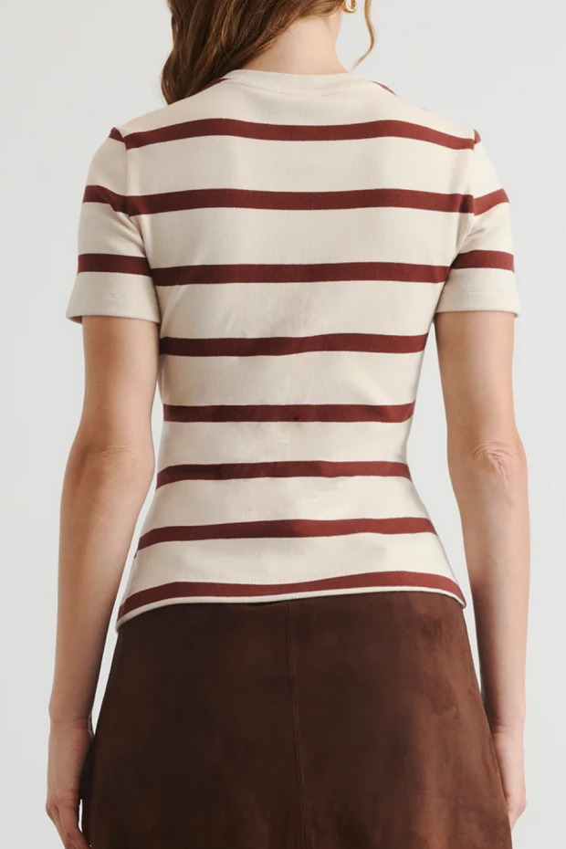 Person wearing a striped shirt with a plain background