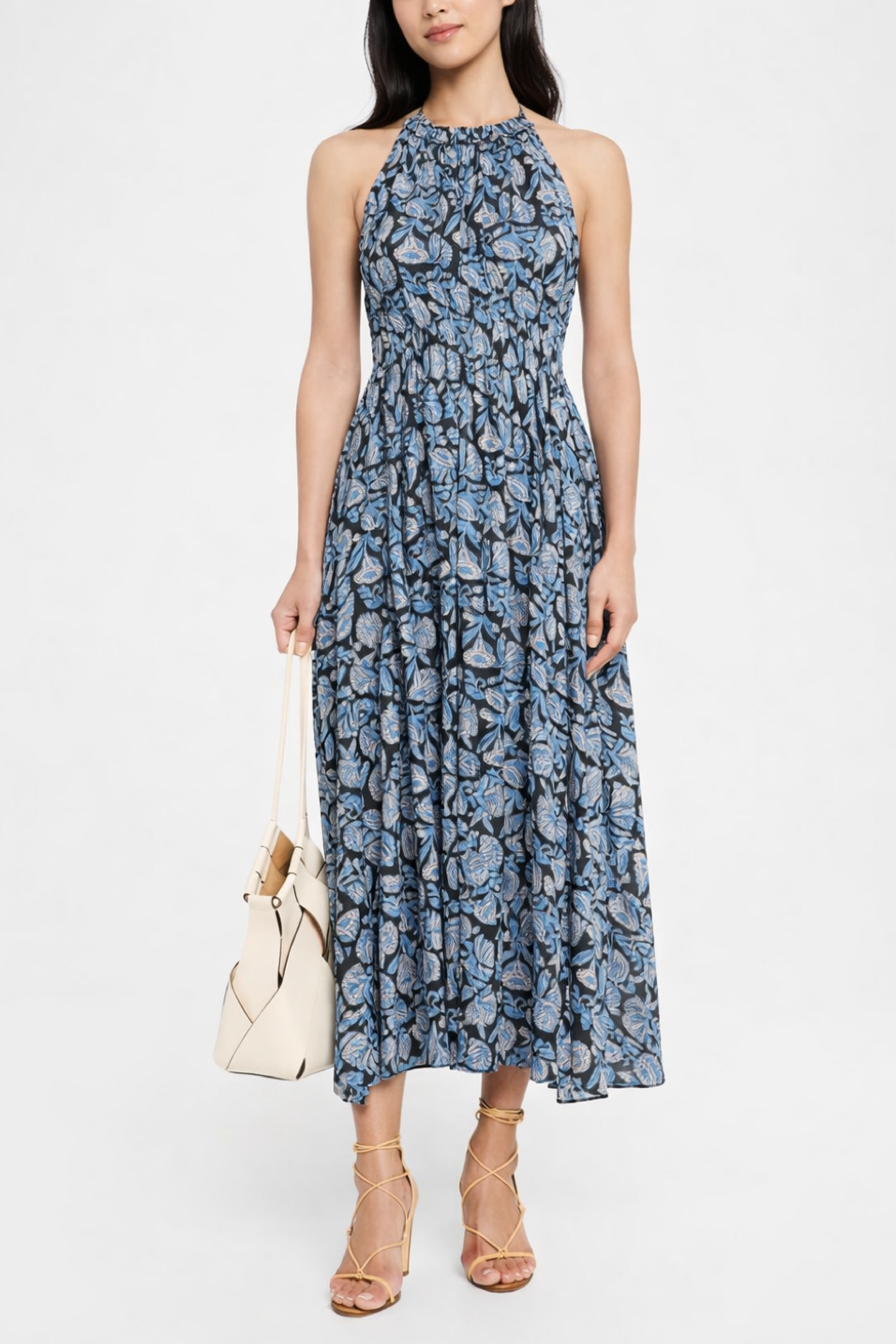 Woman wearing a blue floral dress on a white background