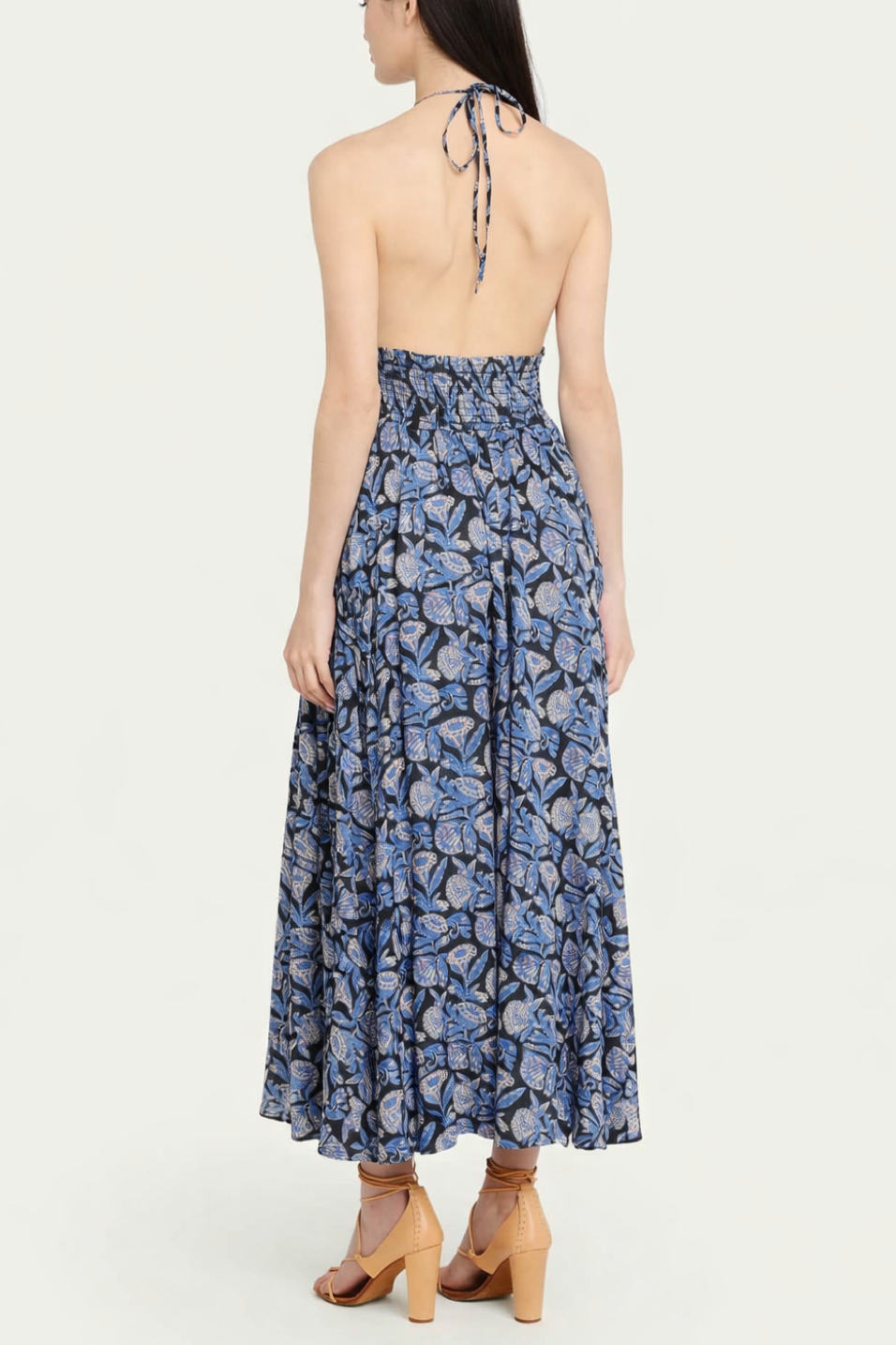 Woman wearing a blue floral dress on a white background