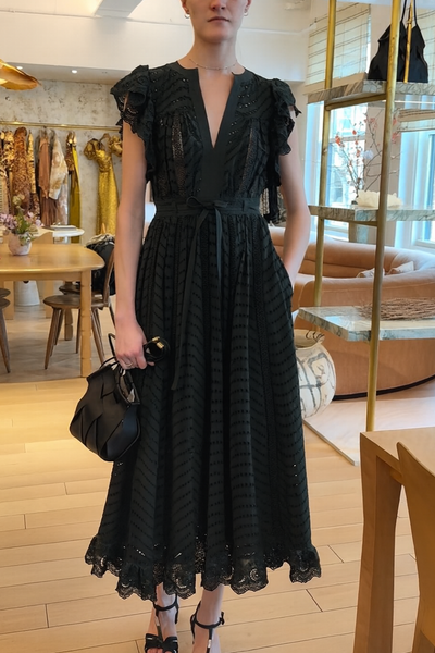Woman wearing a green cypress lace dress in an indoor setting