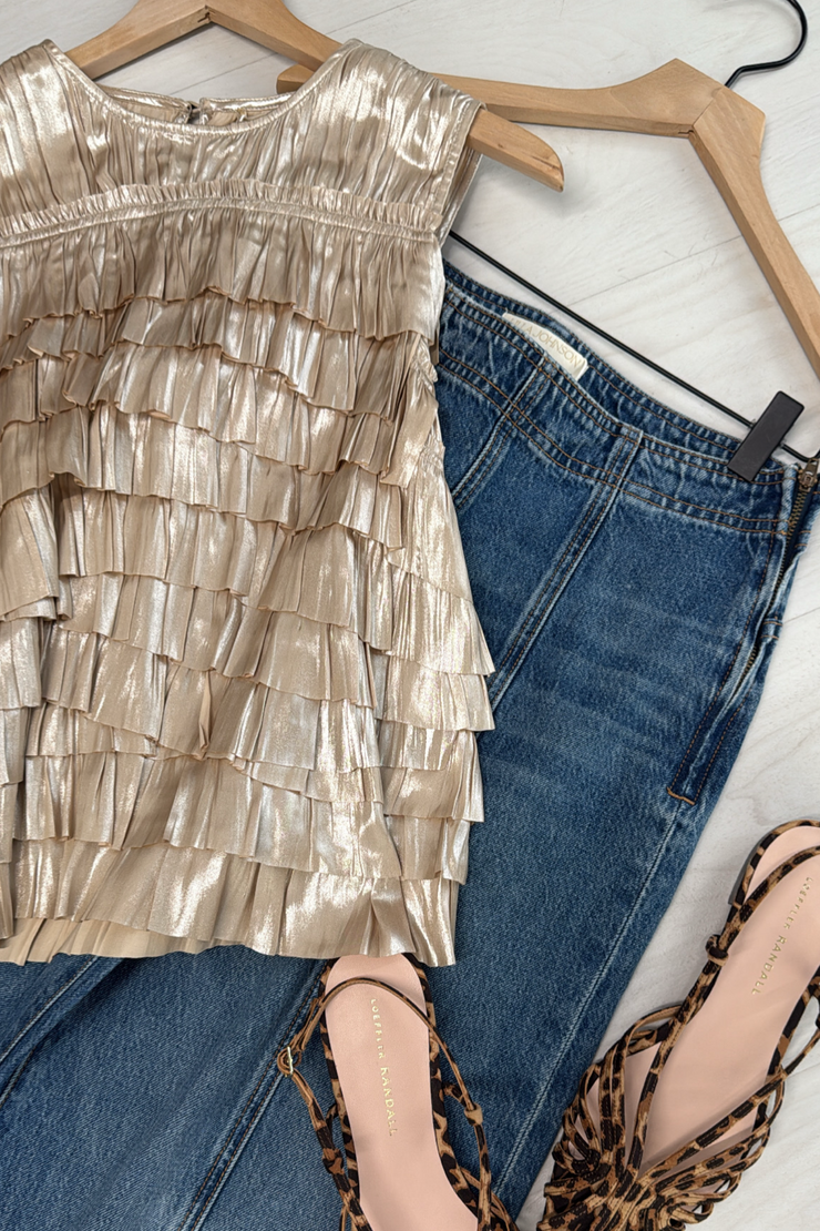 Opal ruffled top, blue jeans, and leopard print shoes on a white surface