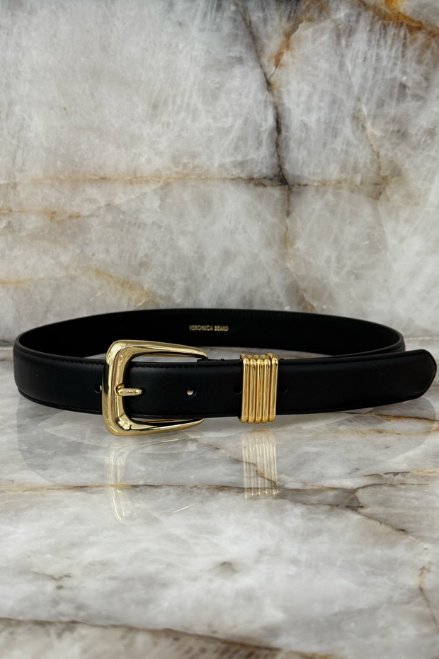 Black belt with gold buckle on a marble surface