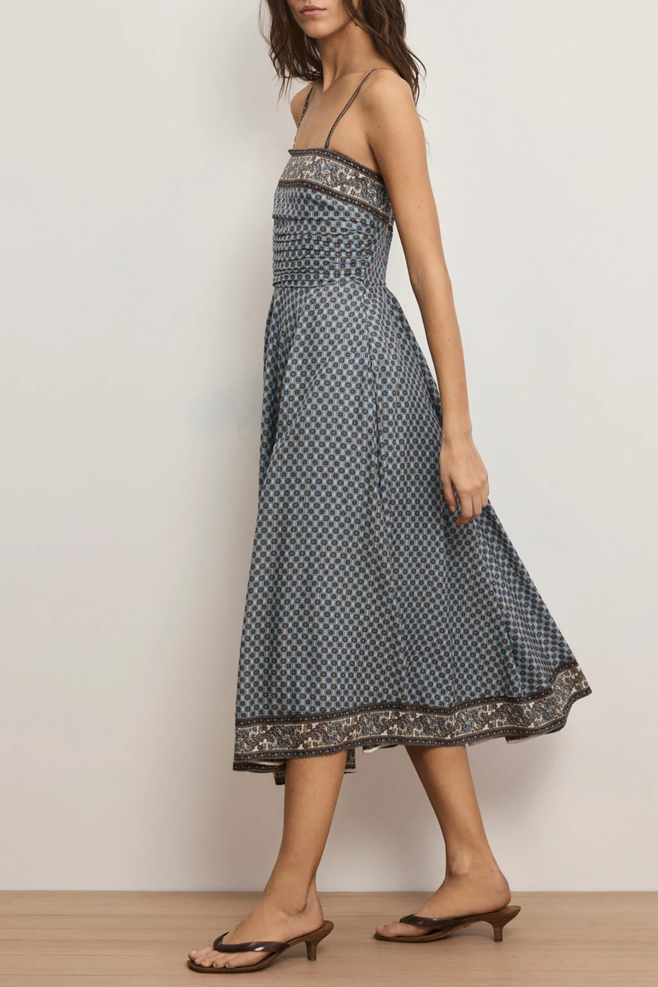 women walking in a blue patterned midi dress