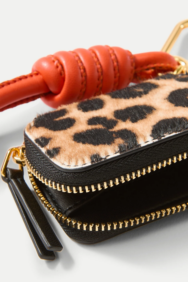 Leopard print pouch with orange strap on a white background