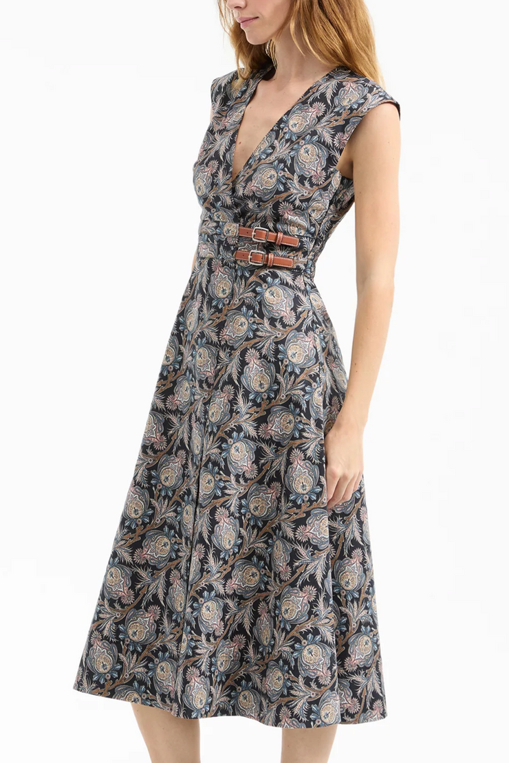 Woman wearing a floral dress with a belt on a white background