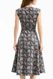 Woman wearing a sleeveless floral dress on a white background