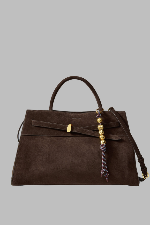 Brown handbag with decorative strap on a white background