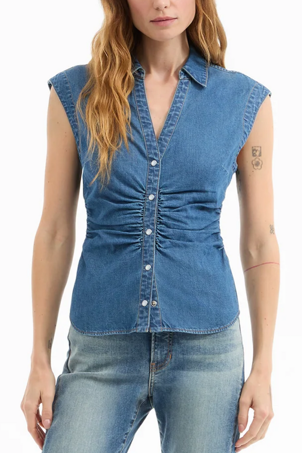 Woman wearing a denim sleeveless shirt on a white background