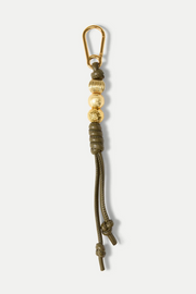 Keychain with gold clasp and green vegan leather on a white background