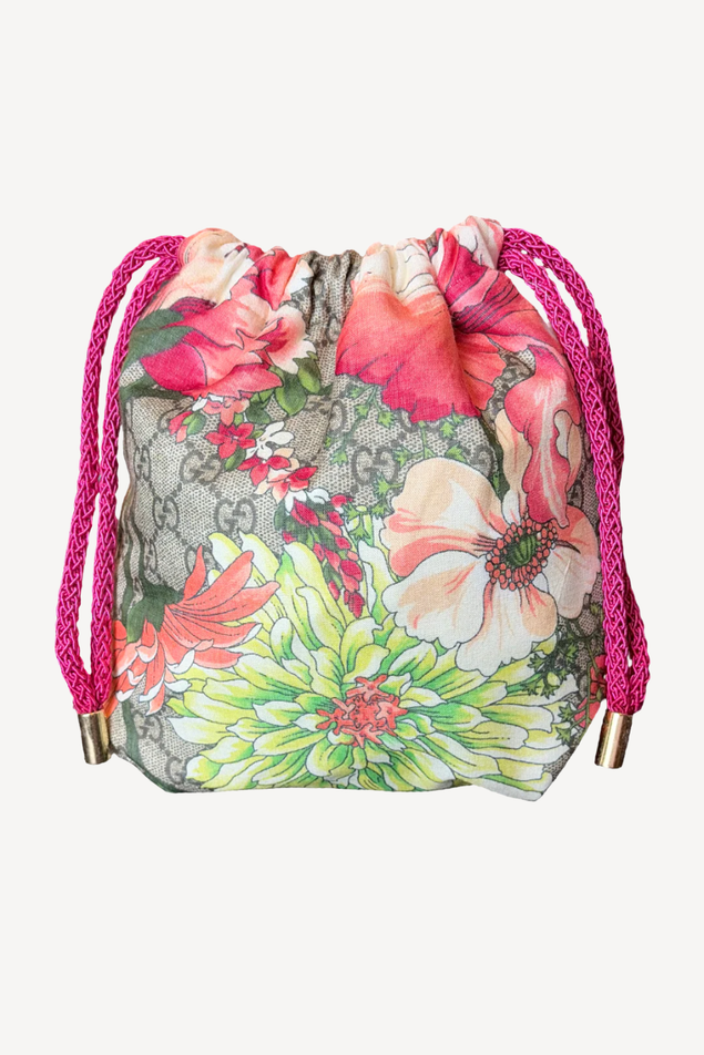 Floral drawstring bag with pink strings on a white background