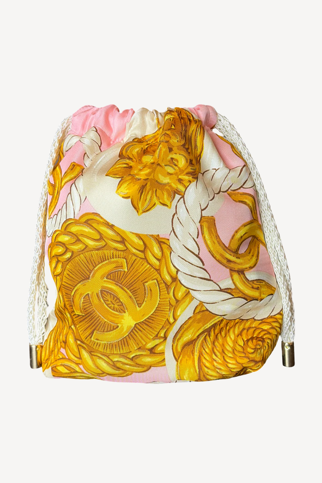 Drawstring bag with floral and CC logo design on a white background
