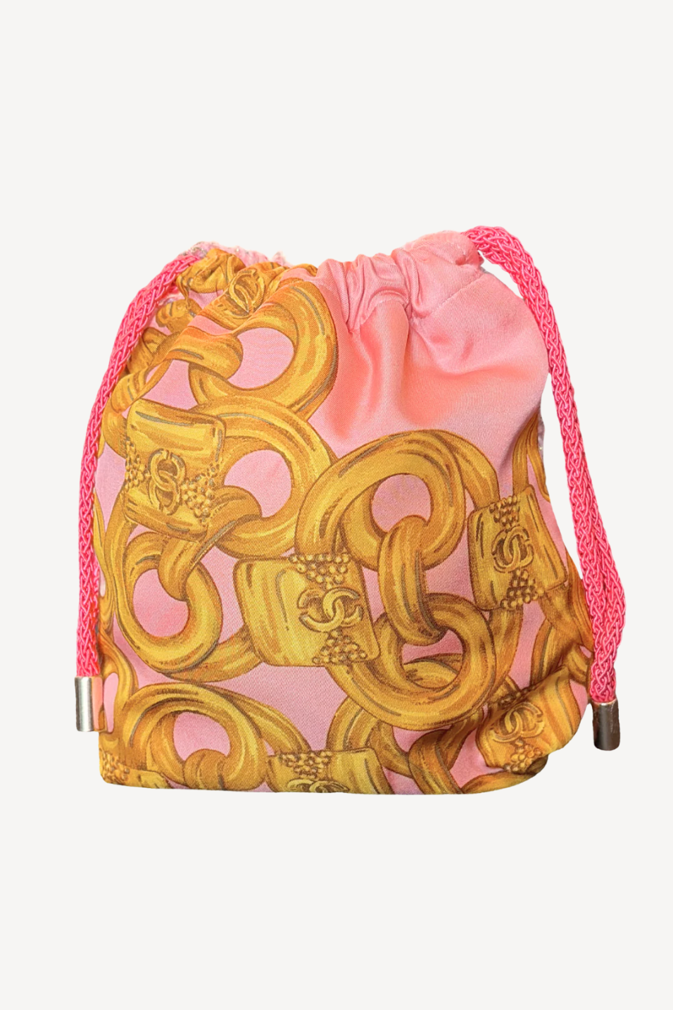 Drawstring bag with gold baroque pattern and pink drawstrings on a white background