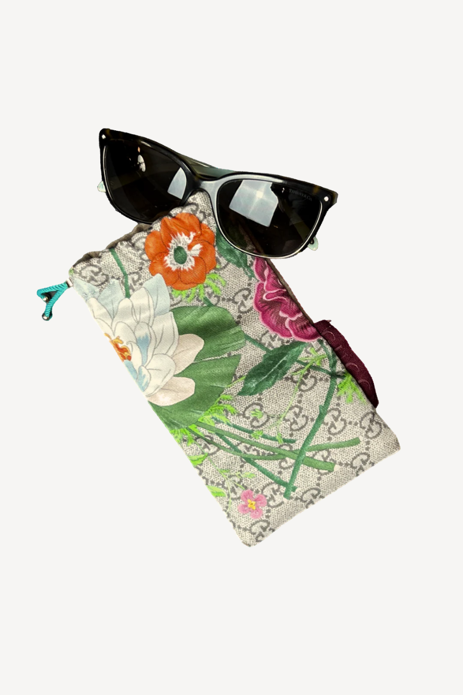 Floral sunglasses case with sunglasses on a white background
