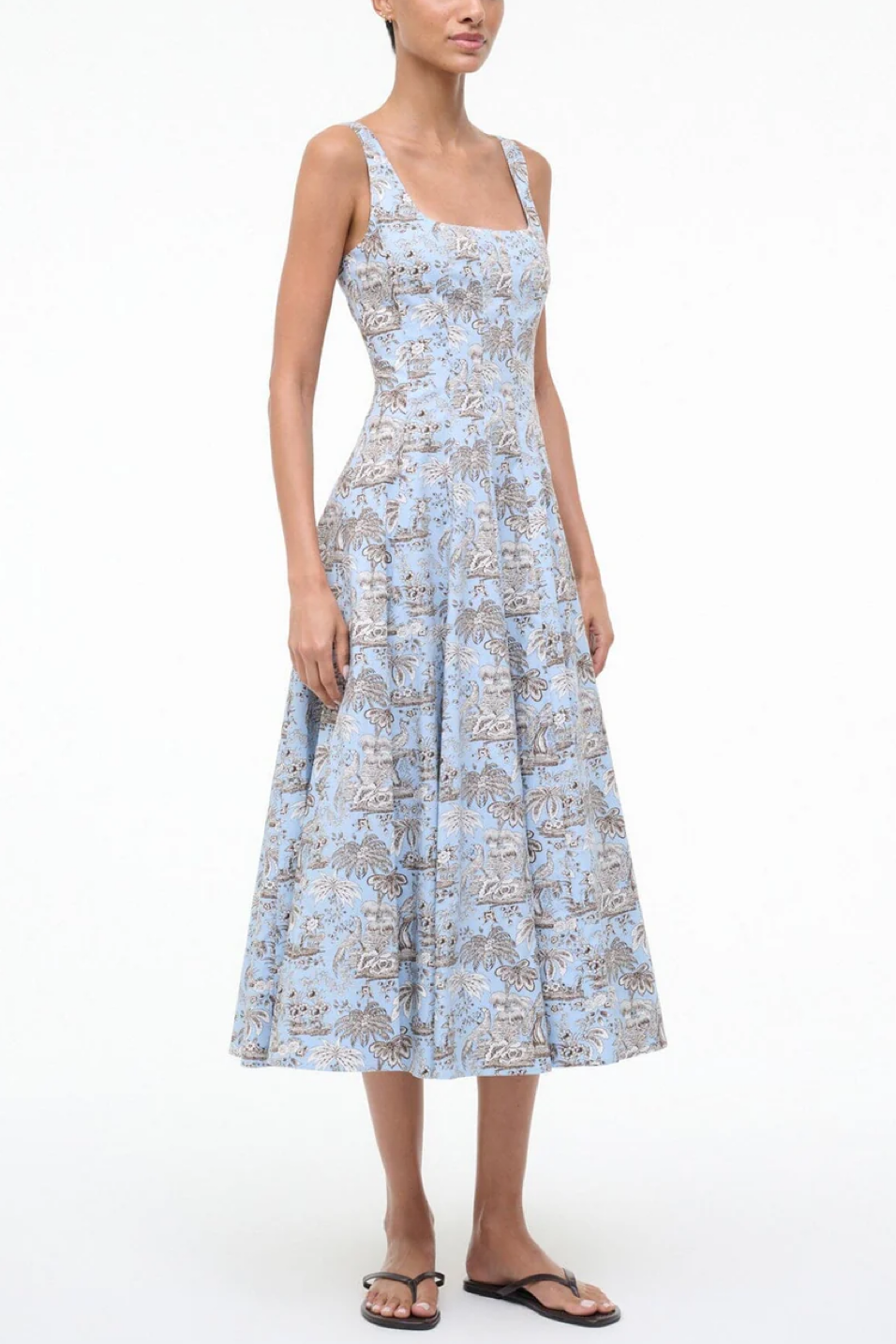 Woman wearing a light blue floral dress on a white background