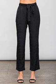 Image of model wearing the SUNDAYS Malone Pant, standing infront of grey backdrop, front view