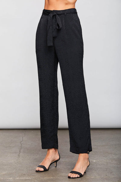 Image of model wearing the SUNDAYS Malone Pant, standing infront of grey backdrop, front view of pant